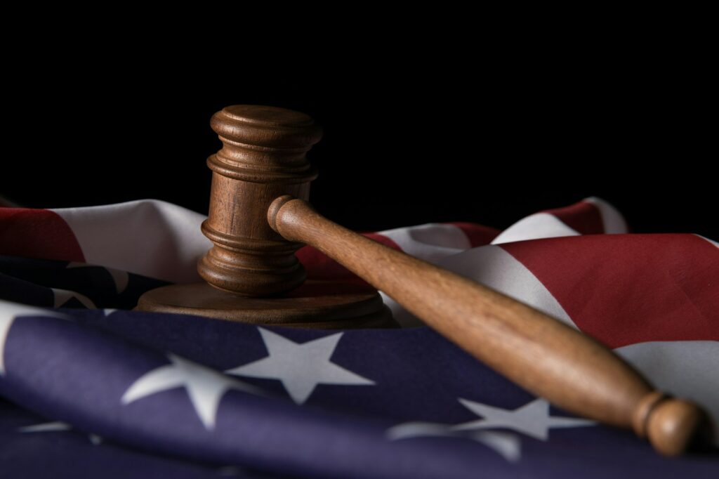 wooden gavel on american flag isolated on black